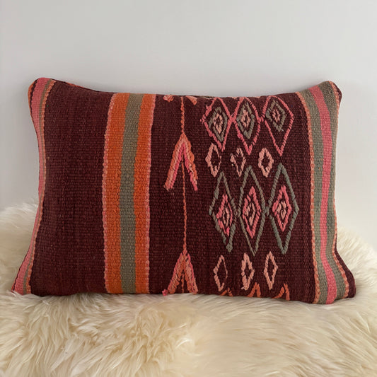 Decorative Vintage Moroccan pillow with geometric pattern on a white surface